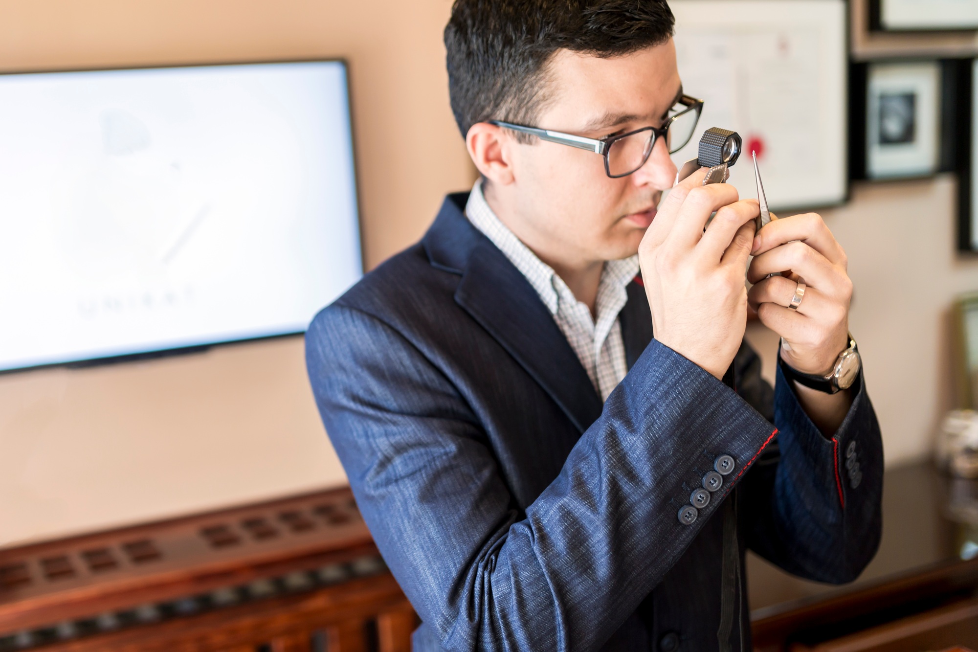 Jeweler looking at diamond through loupe